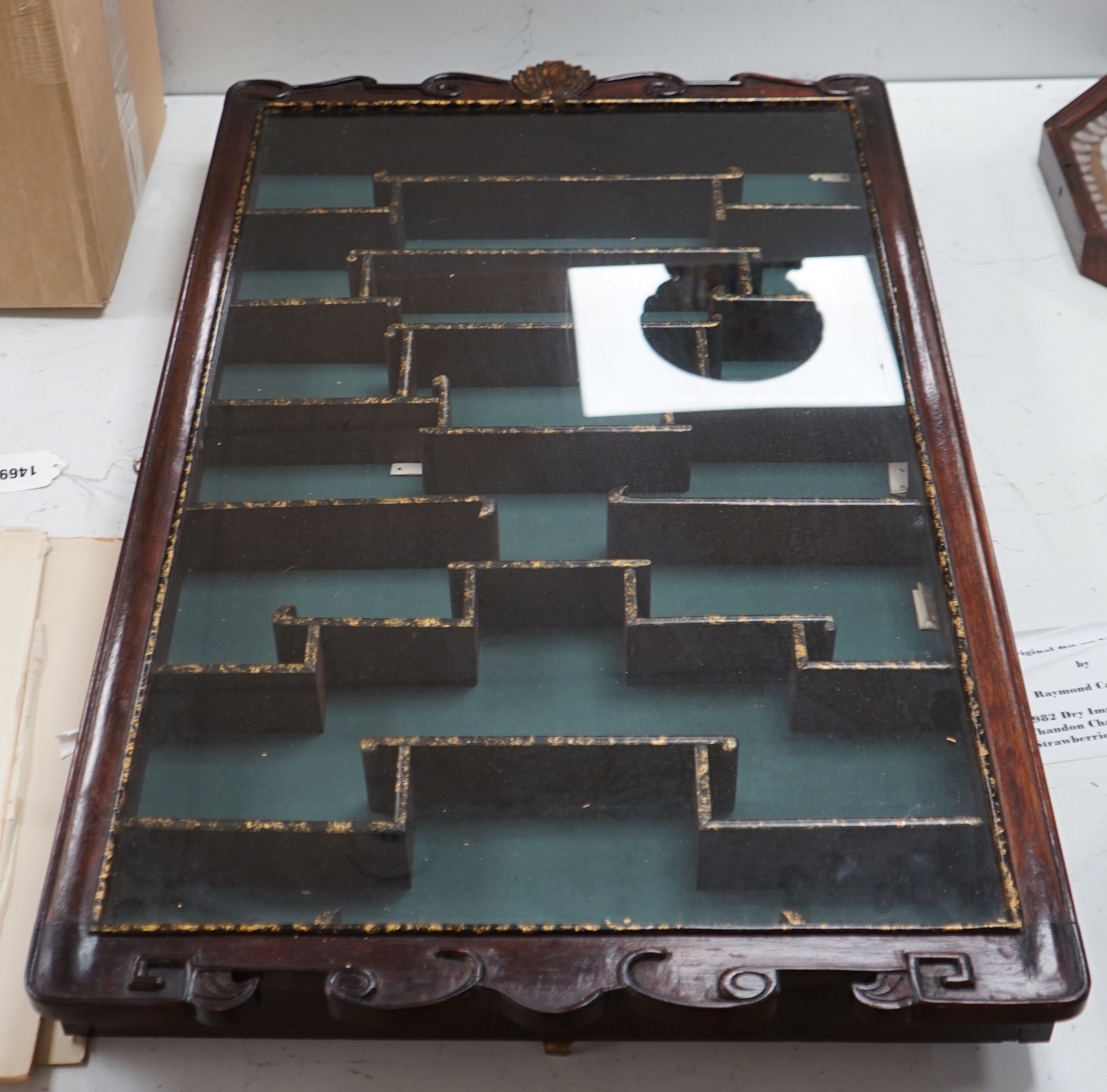 A Chinese hardwood snuff bottle cabinet with glazed front, gilded decoration and key, 84cm high